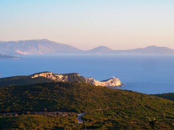 Scenic view of sea and mountains against sky