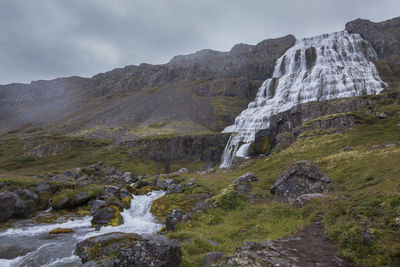 Scenic view of waterfall against sky