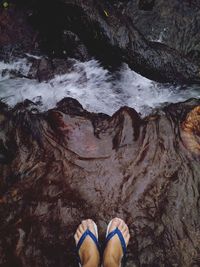 Low section of person standing on rock