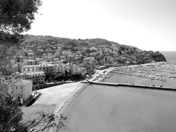 High angle view of road by buildings against sky