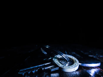 Close-up of machine on table against black background