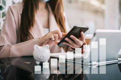 Midsection of woman using mobile phone