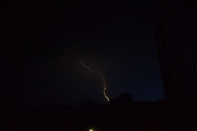 Silhouette of trees against sky at night