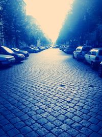 Empty road with trees in background