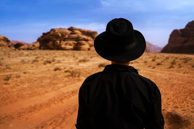 Rear view of person standing in desert