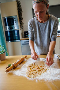 Midsection of man with cookies on table