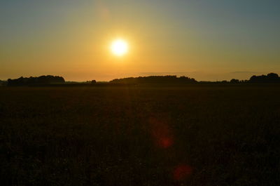 Scenic view of field against sky during sunset