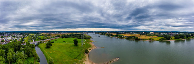 Panoramic view of river and cityscape against sky