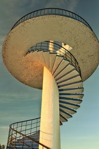 Low angle view of electric lamp against sky