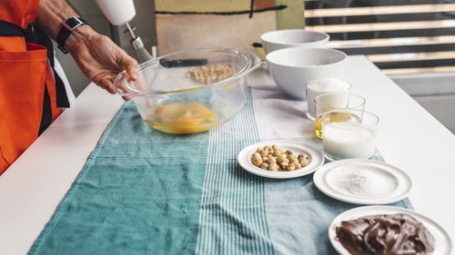 Midsection of man preparing food on table