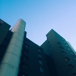 Low angle view of modern buildings against clear blue sky