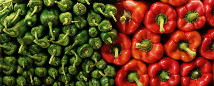Banner with trendy beautiful organic green and red paprika pepper on market. vitamin healthy food 