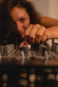 Close-up of fashionable young woman playing music at home