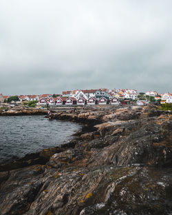 View of townscape by sea against sky