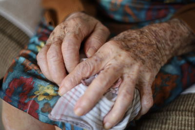Close-up of woman hand on carpet