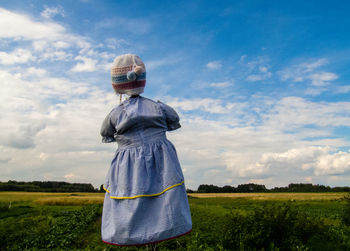 Scarecrow on field against sky