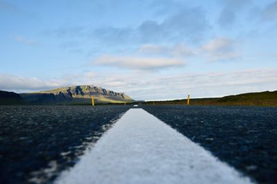 Surface level of empty road against sky