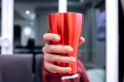 Close-up of woman holding red wine