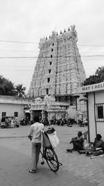 Rear view of man in city against sky