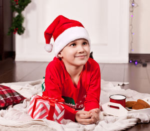 Portrait of smiling young woman sitting at home