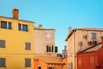 Low angle view of colorfull mediterranen buildings against clear blue sky