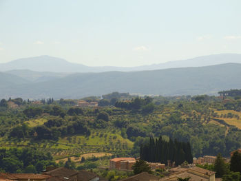 Scenic view of agricultural field and mountains against sky