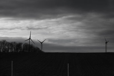 Windmill on field against sky