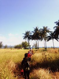 People walking on grassy field