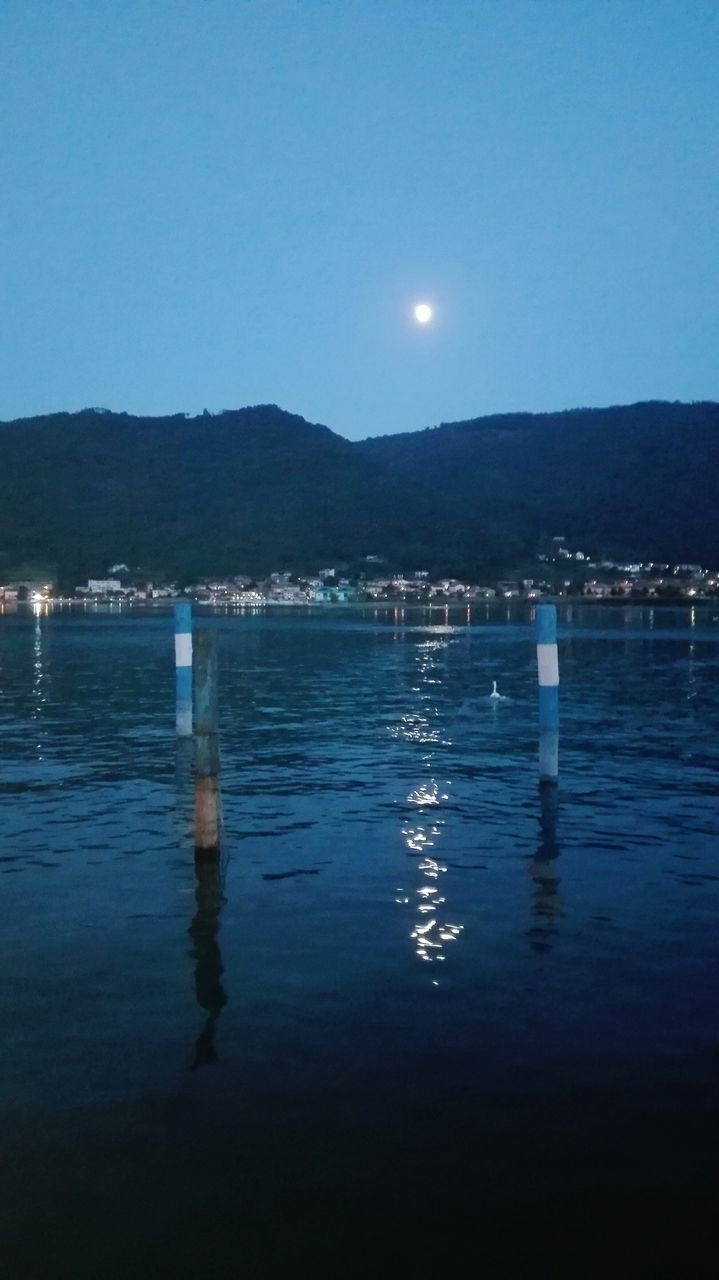 moon, mountain, water, reflection, waterfront, nature, beauty in nature, outdoors, lake, tranquility, scenics, clear sky, no people, sky, illuminated, tranquil scene, night, mountain range, blue