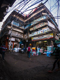 People walking on street against buildings