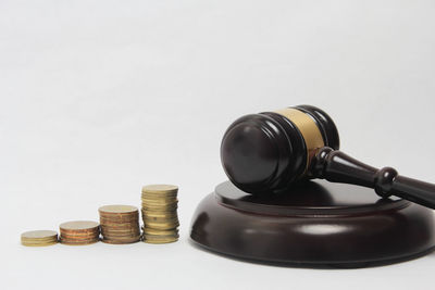 Close-up of coin stack against white background