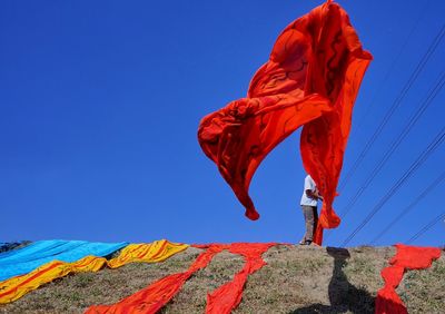 Low angle view of red umbrella against clear sky