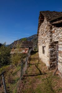 Old ruin building against clear blue sky