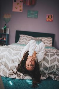 Portrait of girl relaxing on bed at home