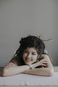 Portrait of smiling young woman lying down