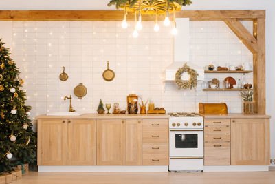 Kitchen with a christmas tree. well lit and has a warm, cozy atmosphere