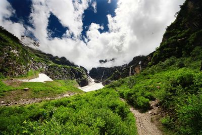 Scenic view of waterfall against sky