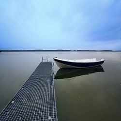 Pier on lake against sky