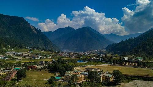 Panoramic view of townscape and mountains against sky