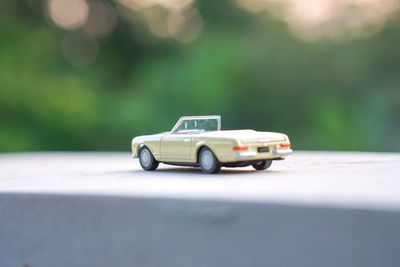 Close-up of toy car on table outdoors