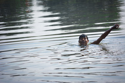 Portrait of man swimming in lake