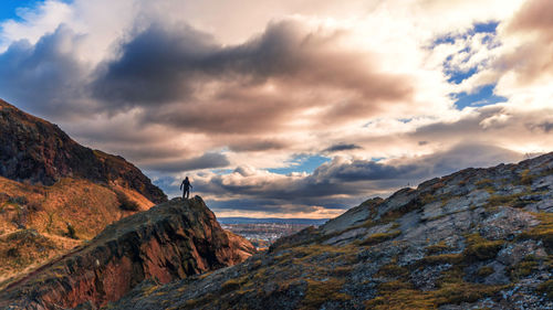 Scenic view of mountains against cloudy sky