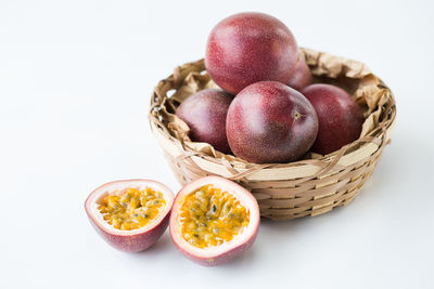 High angle view of fruits in basket on white background