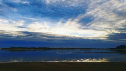 Scenic view of lake against sky at sunset