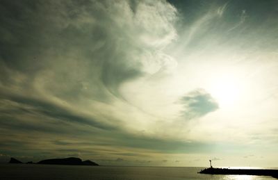 Scenic view of sea against cloudy sky
