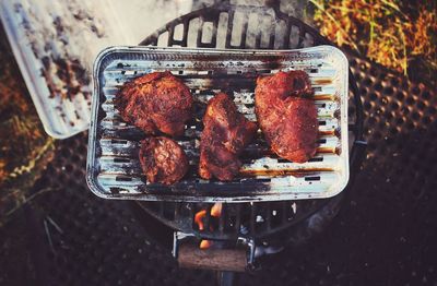 High angle view of meat on barbecue grill