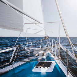 Sailboat sailing in sea against sky