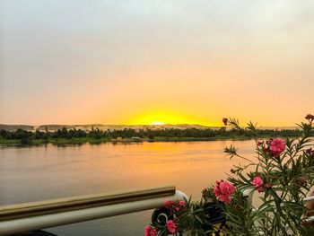 Scenic view of lake against orange sky