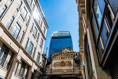 Low angle view of buildings against clear blue sky