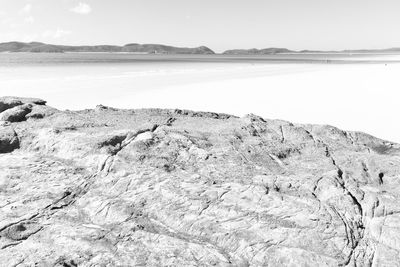 Scenic view of rocks on beach against sky